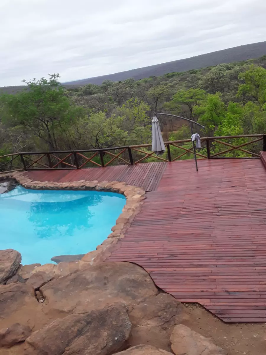 Swimming pool and wooden deck with a scenic view
