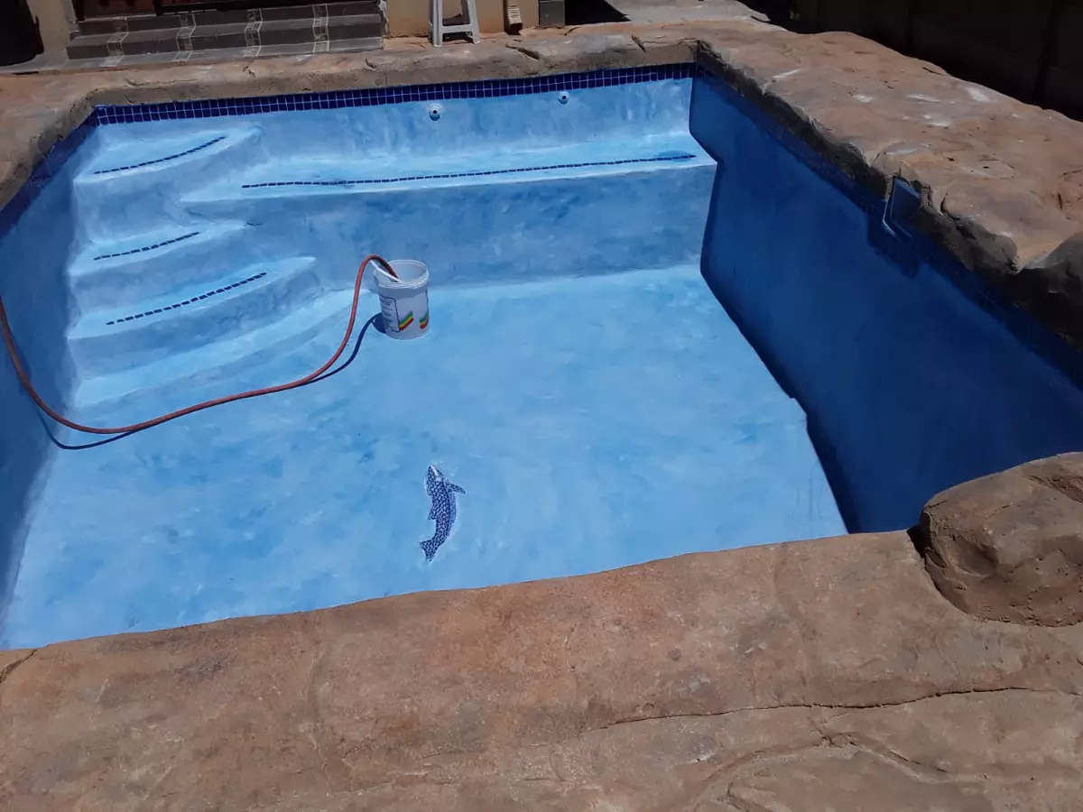 Empty swimming pool during maintenance with blue interior